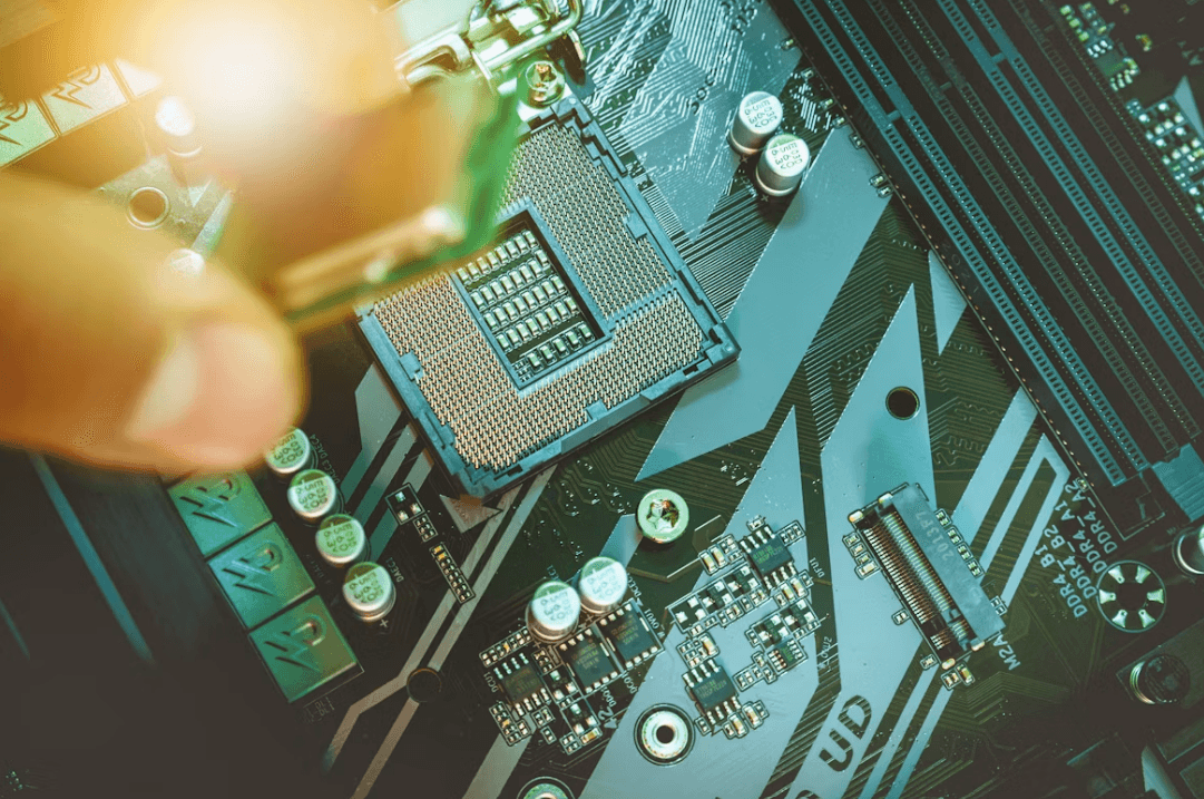 Close-up of a computer motherboard and processor, representing systems security.